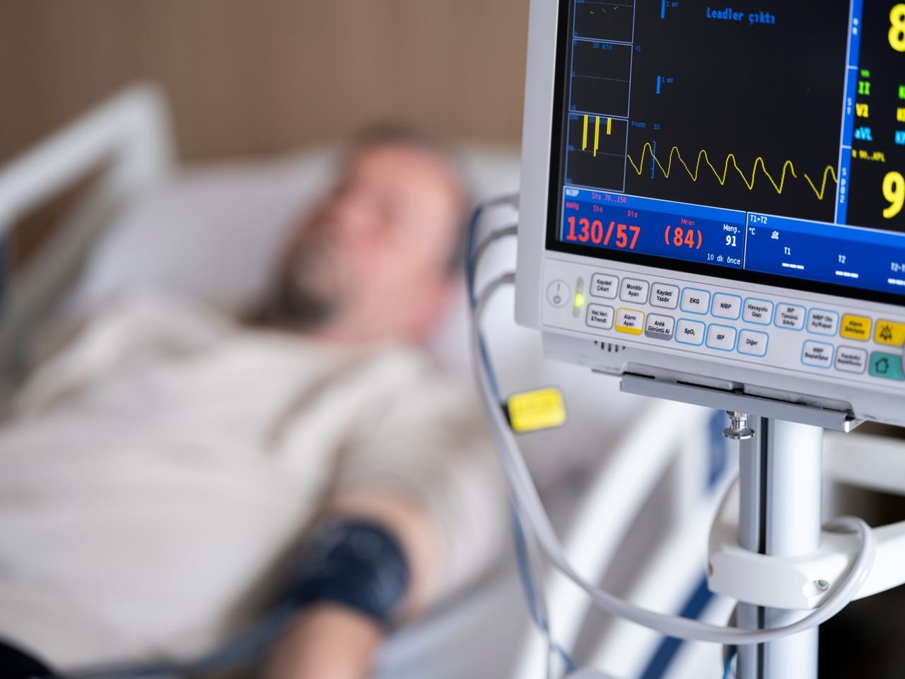 Mastering the First Impression: Your intriguing post title goes here Patient in hospital bed with heart monitor showing blood pressure and heart rate.